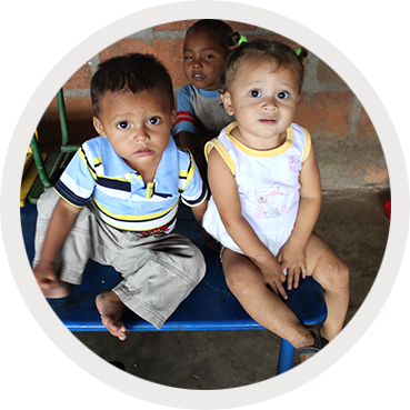 Two children look at the camera, pensive