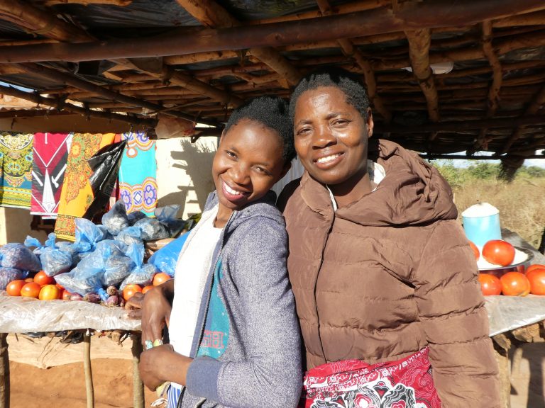 Two women smile