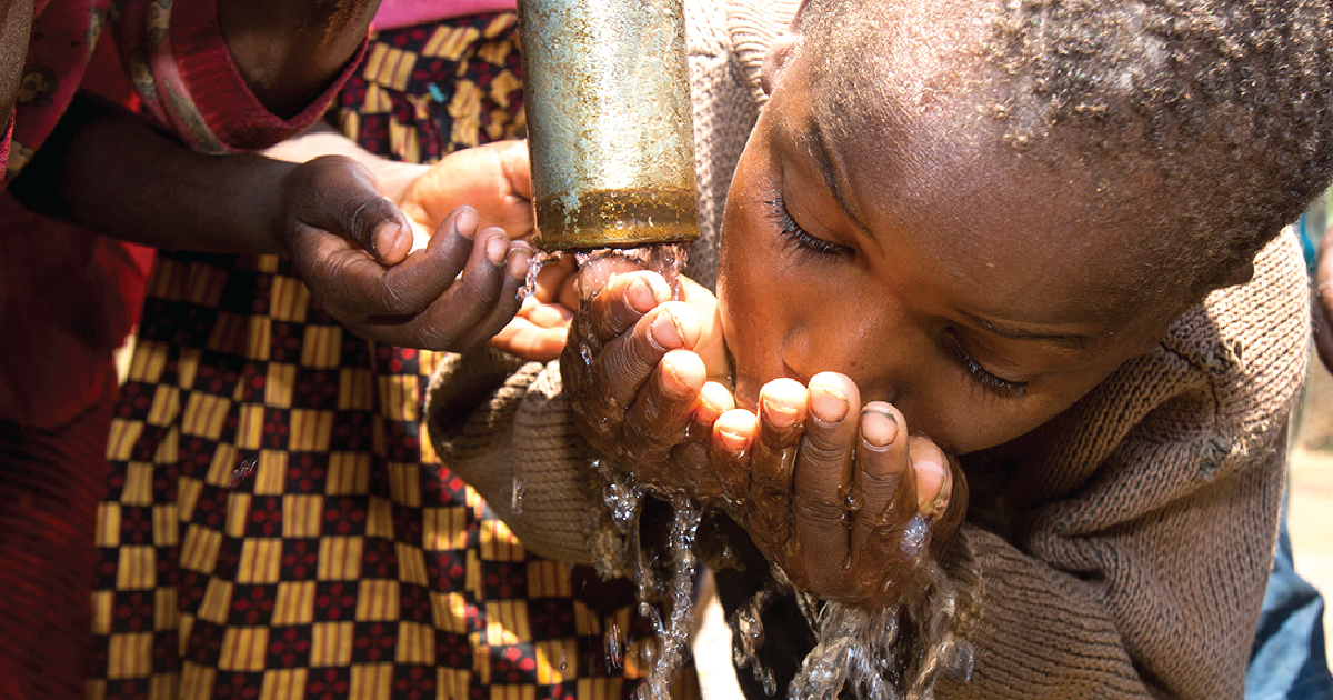 A child drinks clean water from a water well