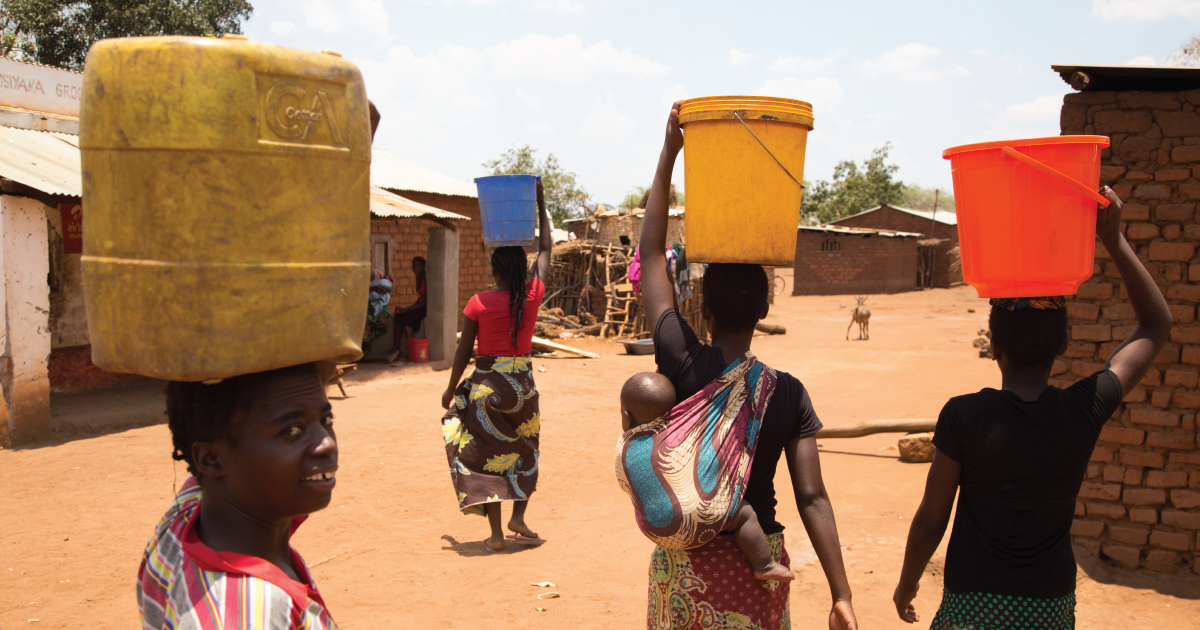 Women carry buckets of clean water on their heads
