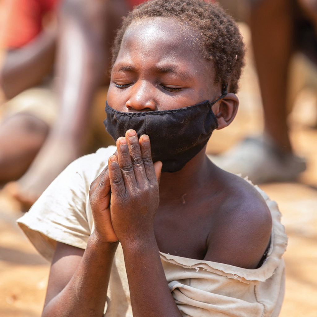 Child in Malawi praying