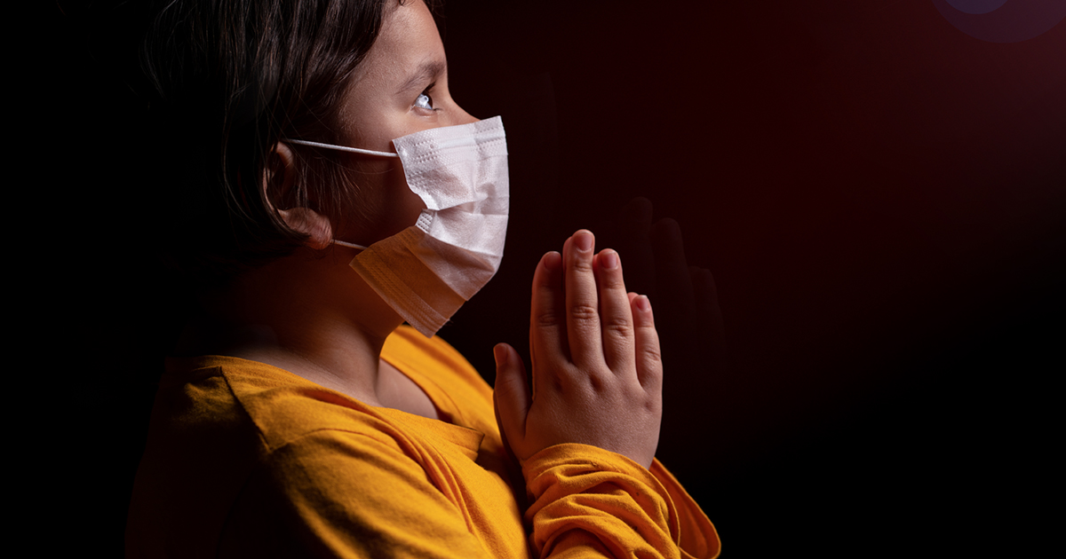 Girl wearing mask praying