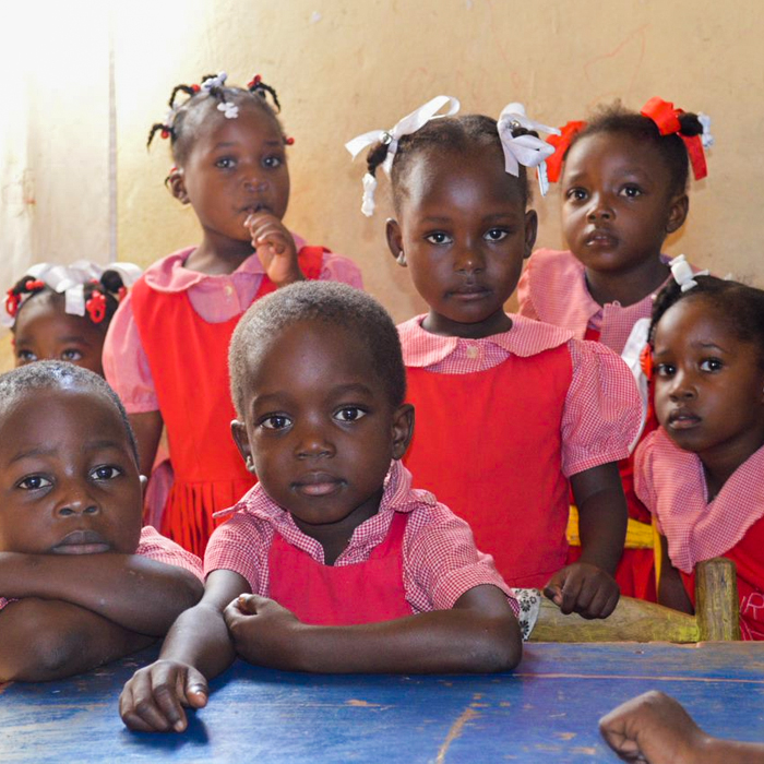 Haitian children in school looking at the camera