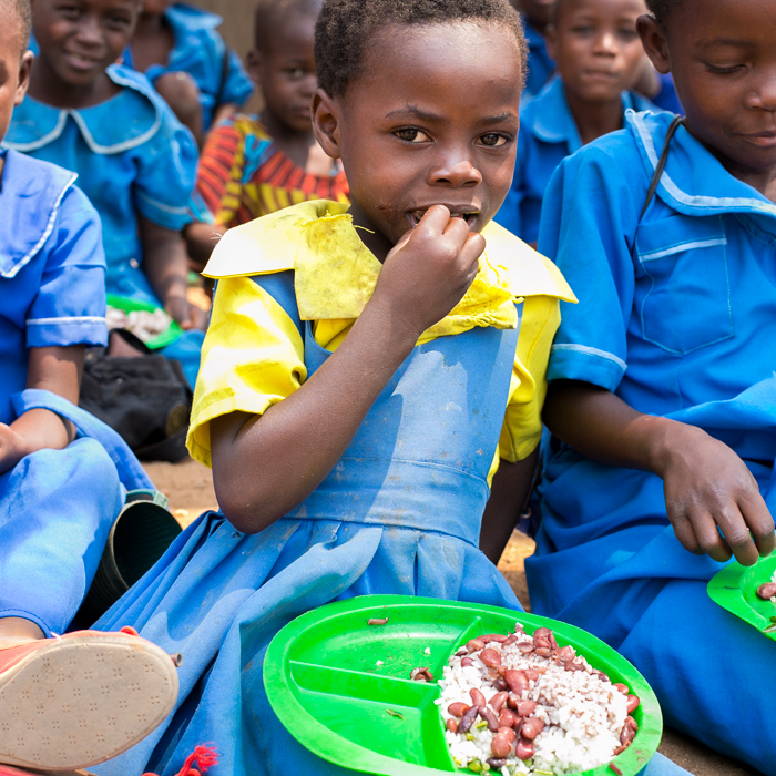 Malawian girl eating lunch at school