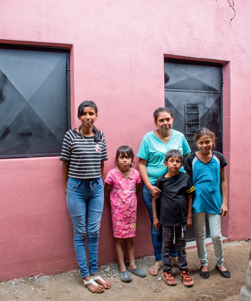 Mailyn Najera and her family in front of their new home