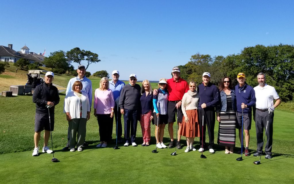 Golfers and significant others posing at the Cross Classic