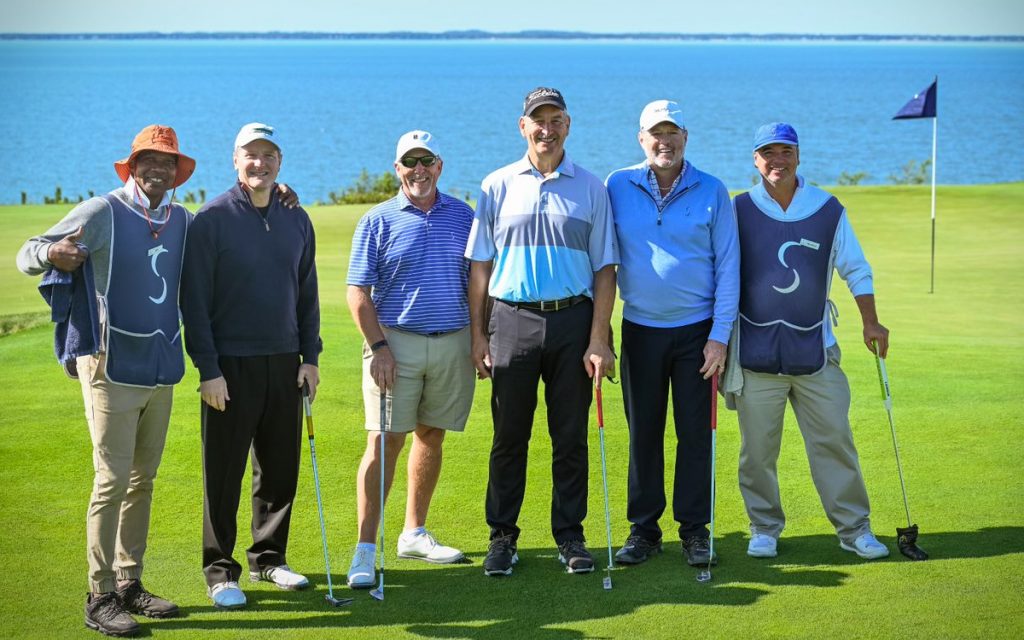 Golfers pose together at the Cross Classic at Sebonack
