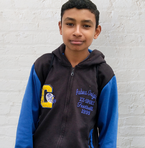 A young boy looks into the camera in Ecuador