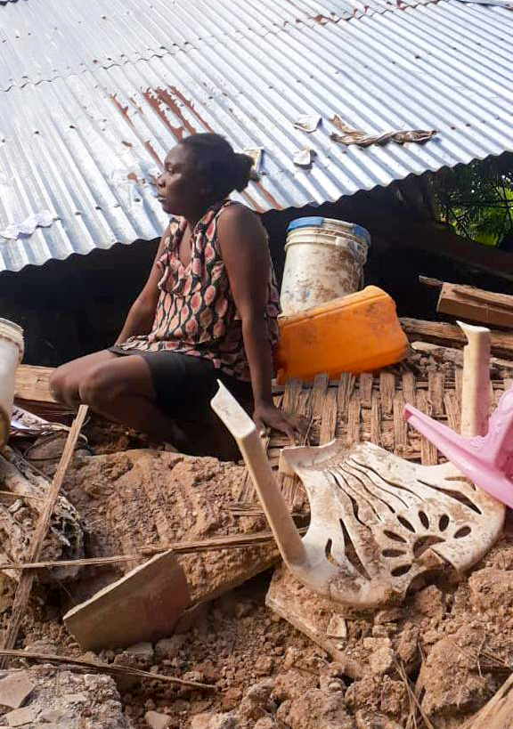 Woman sitting on the rubble of her home in the village of Toirac