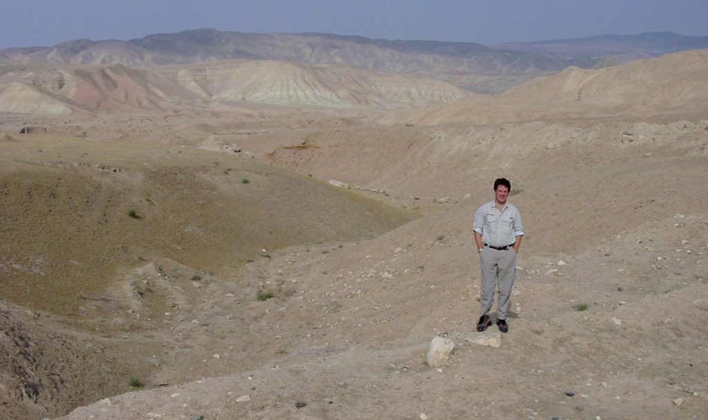 Kelly Miller stands in the mountains of Afghanistan