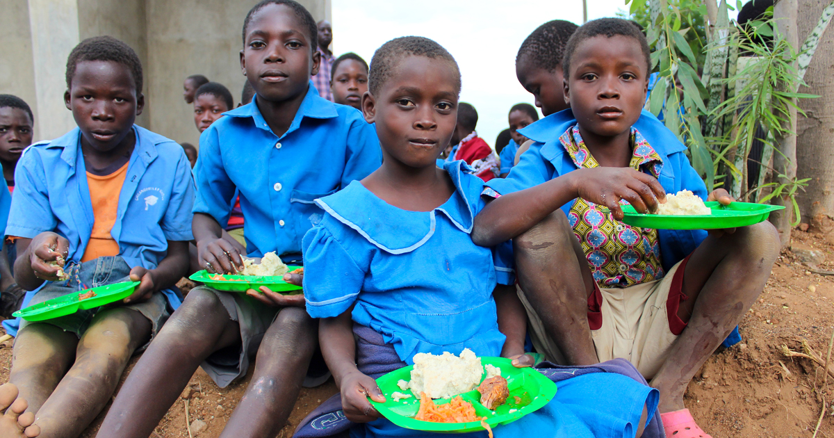 Group of Malawian children receiving lunch