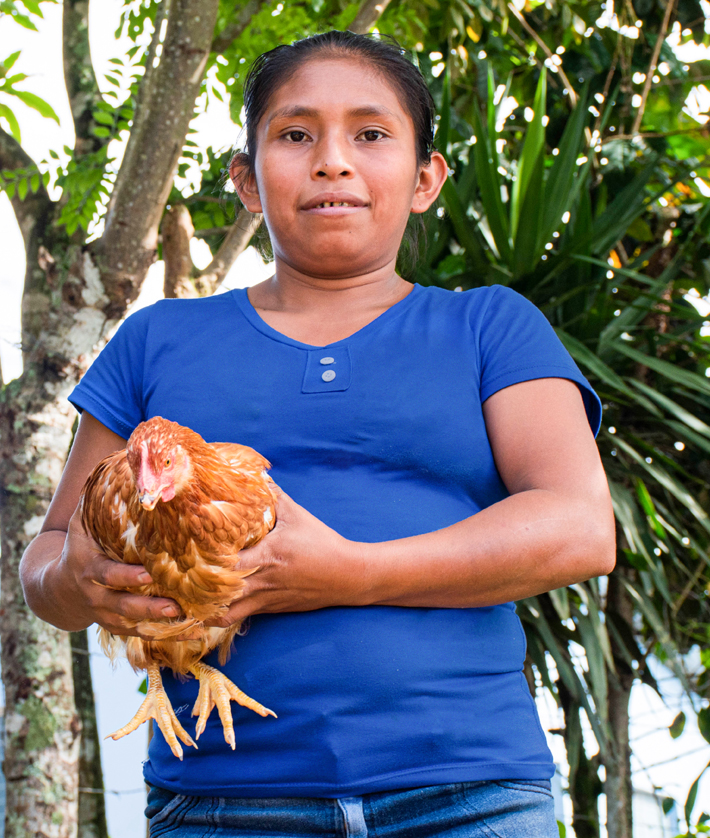 Josefina Garcia holding one of her chickens
