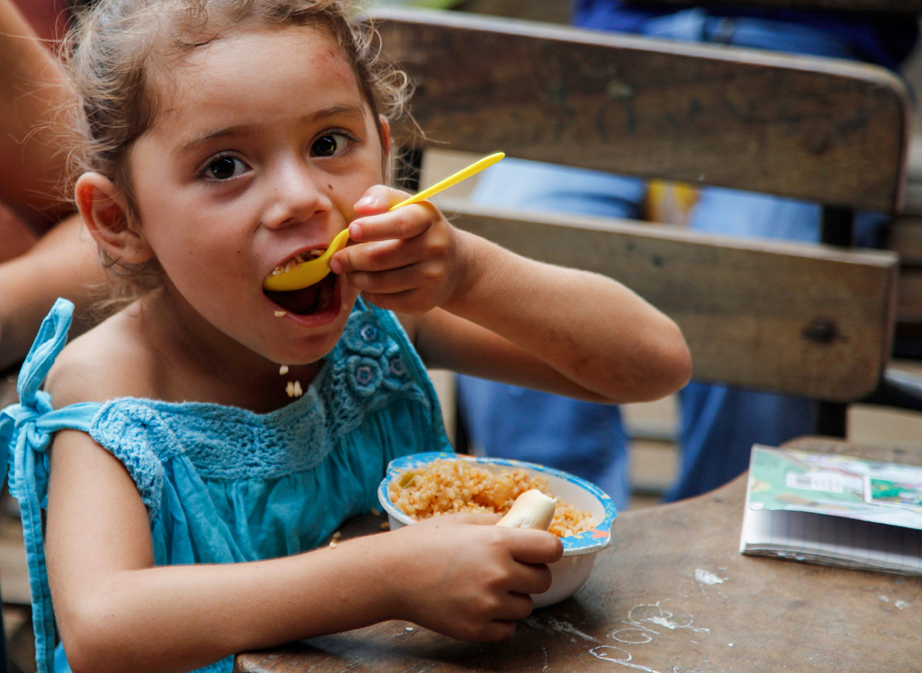 Girl from the Nagarote community in Nicaragua receiving lunch at school feeding