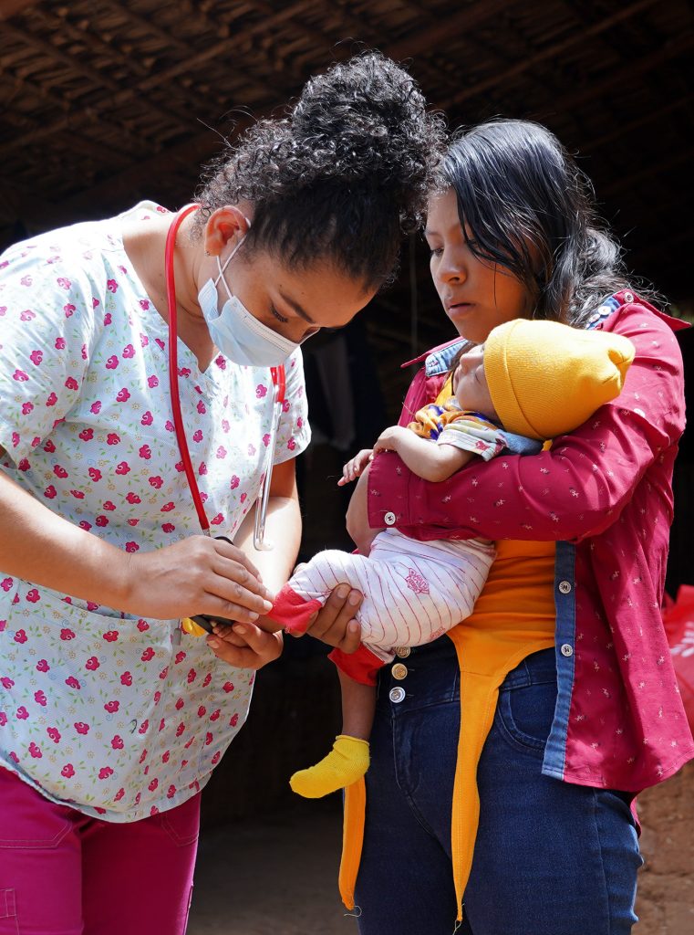 Nurse Hosmary checking two-month-old Yeimi