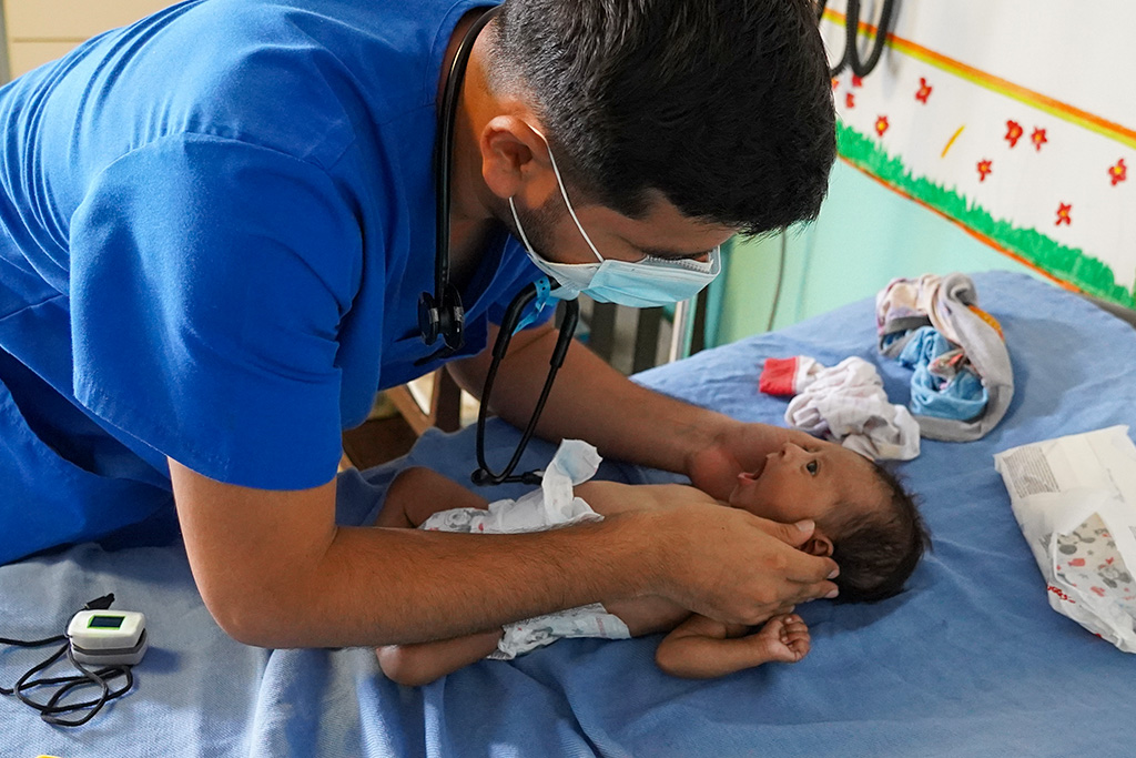 Doctor evaluates baby Yeimi at the Hope of Life Hospital