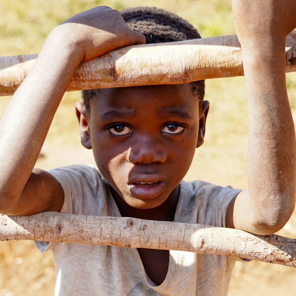Zambian boy from the Agripa village with a look of uncertainty on his face