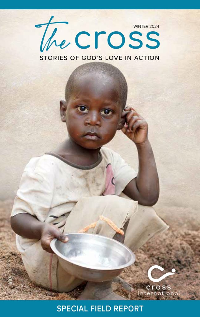 Magazine cover: A young Zambian boy holds an empty bowl hoping for food