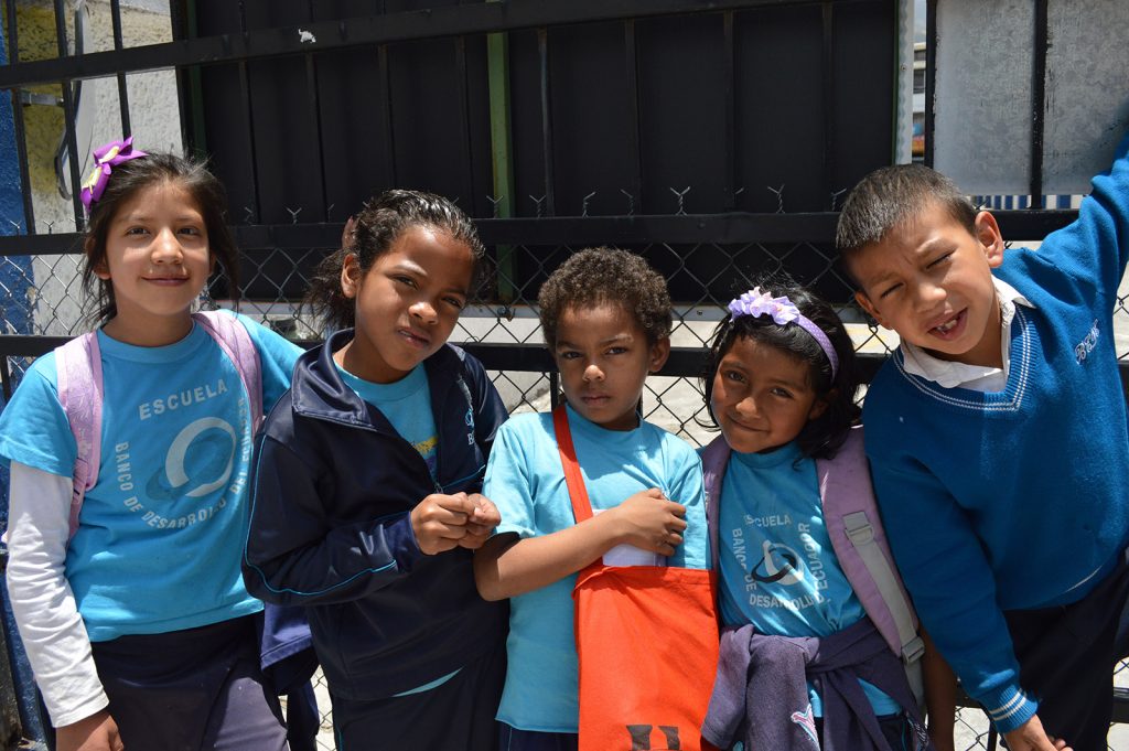 Children in Ecuador wearing backpacks.