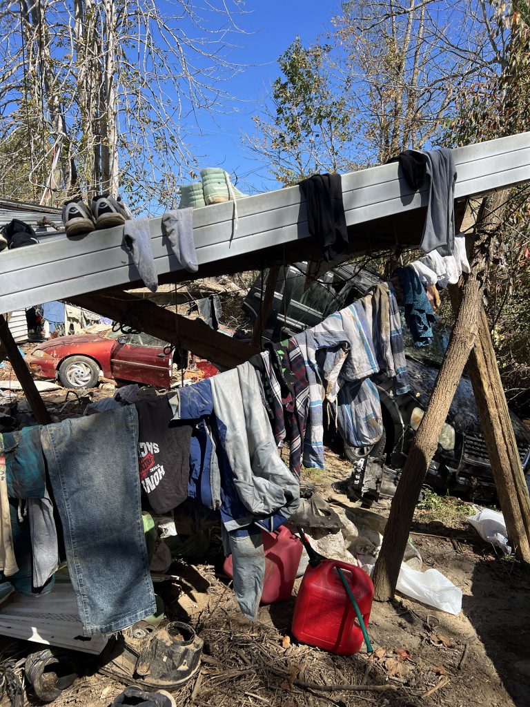 Belongings damaged by Hurricane Helene lined up on a beam to dry.