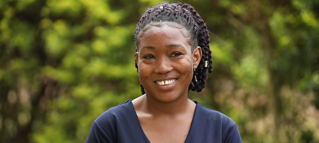 Daisy, a girl from Uganda, smiles as she looks to her future.