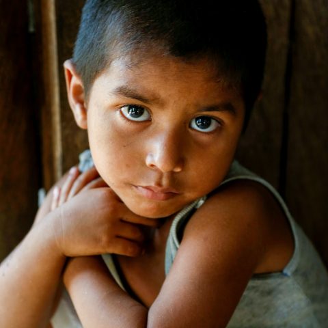 Child in need in Guatemala looks at the camera